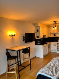 a kitchen with a table and chairs in a room at Studio du cerf in Megève