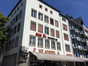 a large white building with a sign on it at XII Apostel Albergo in Cologne