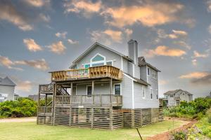 a house with a deck on the side of it at Sanderling Resort Residences in Duck +58 photos