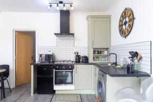 a kitchen with a stove and a dishwasher at 'The Lodge' Bedworth in Bedworth