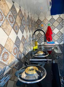 a kitchen with a stove with three plates on it at Comfort and Cozy in Orchha