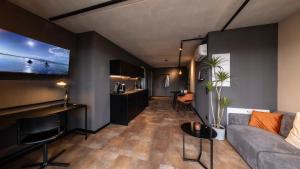 a living room with a couch and a table at Stadthaus Neckarsulm serviced apartments - Stadthaus Heiner in Neckarsulm