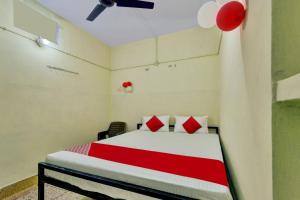 a bedroom with a bed with red and white sheets and balloons at Flagship The Moon Palace in Patna