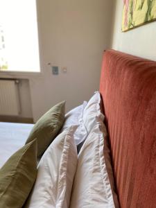 a close up of a bed with pillows on it at apartement Lac 2 in El Aouina