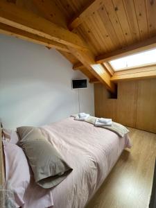 a bedroom with a large bed in a room with wooden ceilings at Duplex en Casco Histórico in León