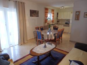 a kitchen and dining room with a table and chairs at Apartments Biočić in Korčula