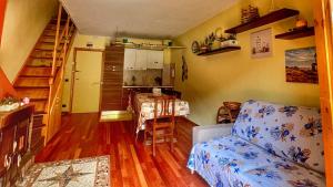 a living room with a couch and a staircase and a kitchen at Brain Residence Laceno in Villaggio Laceno