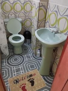 a bathroom with a toilet and a sink at Kiara's house in Puerto Baquerizo Moreno