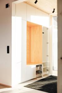 a room with a closet with white cabinets at Premium Ferienhaus Das Farmhaus - Auf den Moselhöhen - Pool, Sauna, Kino, Garten in Lieg