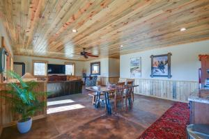 a living room with a wooden ceiling and a table at Cozy Alma Mountain Retreat Fireplace and Grill in Alma