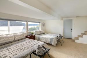 a bedroom with two beds and a large window at Harrison Getaway with Deck and Lake Views! in Harrison