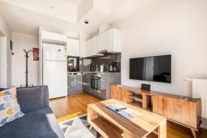 a living room with a couch and a tv at Seba Suites Central Istanbul in Istanbul