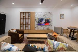 a living room with two couches and a table at Big chill stays East Legon in Accra