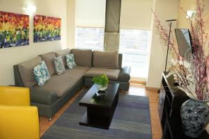 a living room with a couch and a coffee table at Puerta Alameda Suites México in Mexico City