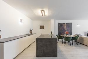 a kitchen and dining room with a table and chairs at BNB SK Zámocká Artist Apartment in Bratislava