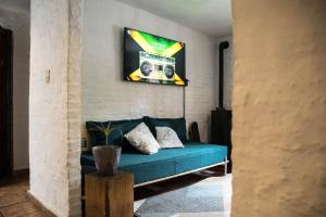 een woonkamer met een bank en een radio aan de muur bij MedioMundo Hostel in Montevideo