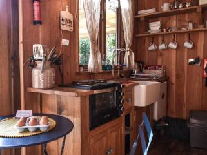 a kitchen with a table with eggs on it at Wampford Woodland Retreat - Kings Cabin in George Nympton