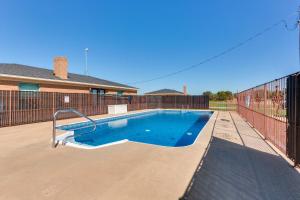 a swimming pool in a yard next to a fence at Ranch Getaway with Pool and Horse Stall Access! in Calera