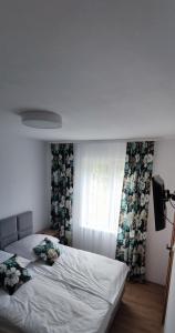 a bedroom with a bed and a window with curtains at Zakręt Solina 537-791-246 in Solina