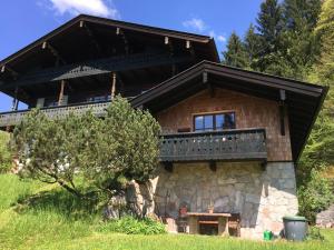 a house with a balcony on the side of it at Waldhofalm Angerer in Berchtesgaden