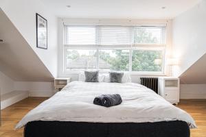 a bedroom with a large bed and a large window at Spacious 2 Bedroom Apartment in Hackney in London