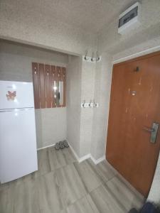 um quarto vazio com um frigorífico e uma porta em Apartament cu 2 camere em Hunedoara