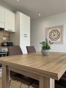 a kitchen with a wooden table and chairs at Beautiful Apartment Aguycan Beach 120 Playa del Aguila Maspalomas Gran Canaria in Maspalomas