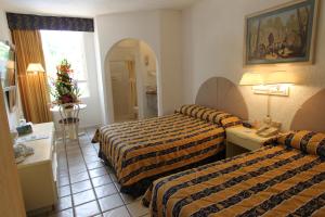 Postel nebo postele na pokoji v ubytování Hotel Plaza Caribe