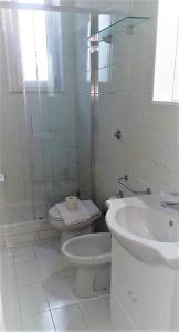 a white bathroom with a toilet and a sink at Cozy flat in Testaccio in Rome