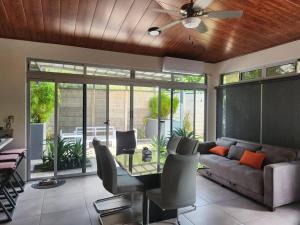 a living room with a couch and a ceiling fan at CASA DE PLAYA AMUEBLADA in Quebrada Ganado