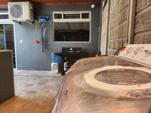 a room with a bed and a desk with a fan at CASA DE PLAYA AMUEBLADA in Quebrada Ganado