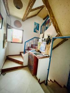 a room with a staircase and a bunk bed at Tamraght White Hostel in Tamraght Ouzdar