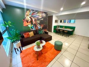a living room with a couch and a table at 3 Bed sheets with pool and Gym in "Uno Urban Life in Guadalajara