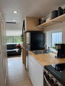 a kitchen with a sink and a counter top at The Mockingbird Tiny Home in Perry