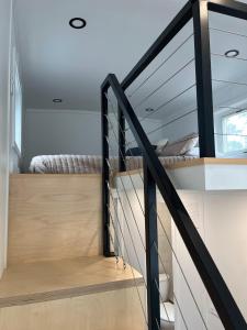 a staircase leading to a bedroom in a house at The Mockingbird Tiny Home in Perry
