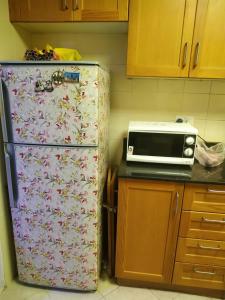 a kitchen with a refrigerator and a microwave at Ruby Star Hostel Dubai for Male- 4 R- 4 in Dubai