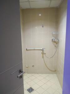 a bathroom with a shower with a hose in it at Ruby Star Hostel Dubai for Male- 4 R- 4 in Dubai