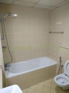 a bathroom with a bath tub and a toilet at Ruby Star Hostel Dubai for Male- 4 R- 4 in Dubai