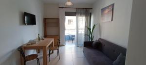 a living room with a couch and a table at North Bay Apartments in Rhodes Town
