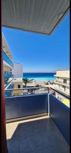 a view of the beach from the balcony of a building at North Bay Apartments in Rhodes Town