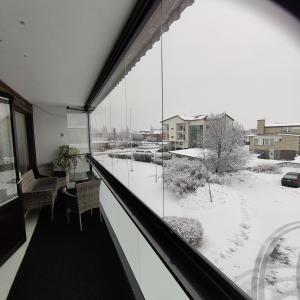 a balcony with a view of a snow covered yard at GREEN in Närpiö