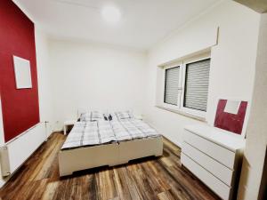 a white bedroom with a bed and a window at 3 Zimmer Wohnung EG - Zentrum in Bocholt