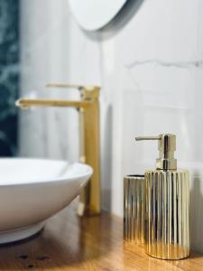 a bathroom with a sink and aaucet next to a white sink at NewEra Apartment 1 