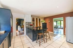 a kitchen with a island in the middle of a room at Chichester Retreat with Large Private Mature Garden in Chichester