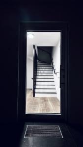 a view of a stairwell through a doorway at NewEra Apartment 1 