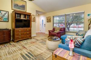 a living room with a blue couch and a tv at Orlando Home with Private Pool 10 Mi to UCF Campus! in Orlando