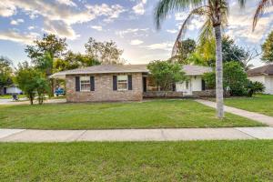 a house with a palm tree in a yard at Orlando Home with Private Pool 10 Mi to UCF Campus! in Orlando