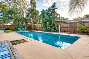 a swimming pool in a backyard with a wooden fence at Orlando Home with Private Pool 10 Mi to UCF Campus! in Orlando
