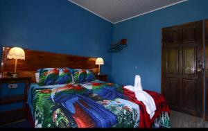a bedroom with a bed with a colorful blanket at Yanu’s casita in Guaria