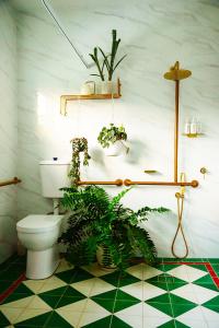 a bathroom with a toilet and plants on the floor at The Old Church Maleny in Maleny